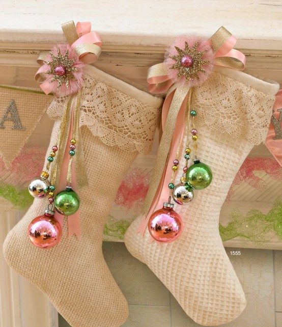 refined vintage neutral stockings with pink and gold brooches and green, gold and pink ornaments on them are amazing Christmassy decor