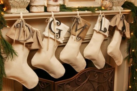 tan and white fabric stockings with monograms are amazing to style a neutral space for Christmas without interfering into the color scheme