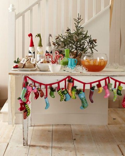 a drink station with a colorful mini stocking garland accenting it is a lovely idea for a modern Christmas space with plenty of color