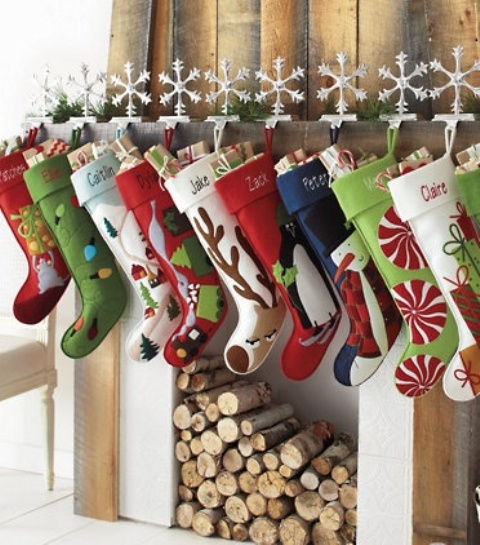 colorful stockings attached to the mantel with snowflakes will make your space more fun, bright and Christmassy