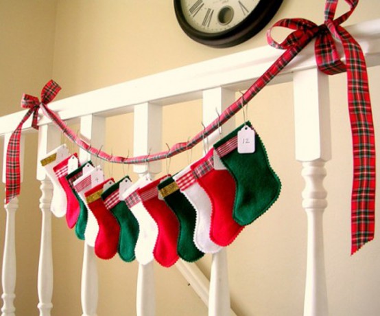 a bright holiday garland of colorful mini stockings on a red plaid ribbon is a cool idea for styling your mantel or railing, and you can DIY it