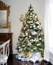 winter wonderland Christmas tree decor in white and silver, with fluffy garlands, snowflakes, lights, animal silhouettes
