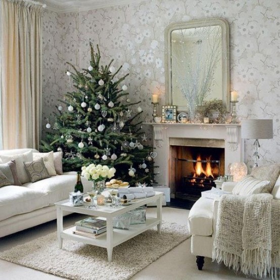 a delicate Christmas tree decorated with white and sheer ornaments is a chic and cool idea for a modern space with a touch of glam