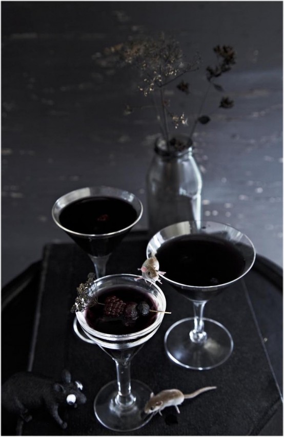 black and deep purple cocktails topped with frozen berries are delicious for Halloween parties