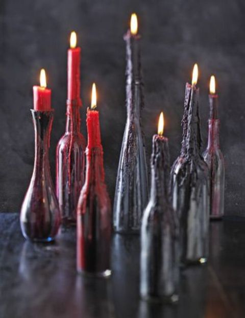 black bottles with peep purple and red candles waxing on them are great for Halloween decor