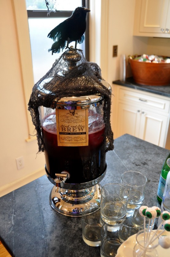 a tank with burgundy lemonade, blackcheesecloth and a crow on top for perfect Halloween styling