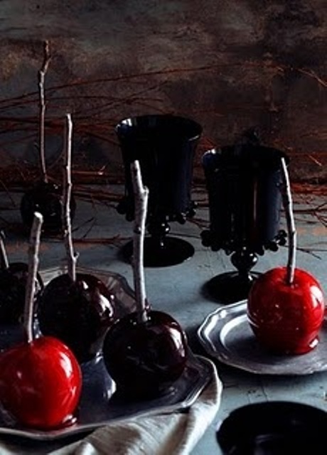 black, red and deep purple candied apples on sticks are lovely Halloween desserts to rock