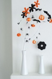 white vases with black and orange blooms, pumpkins and black spiders is a lovely minimal decoration for Halloween