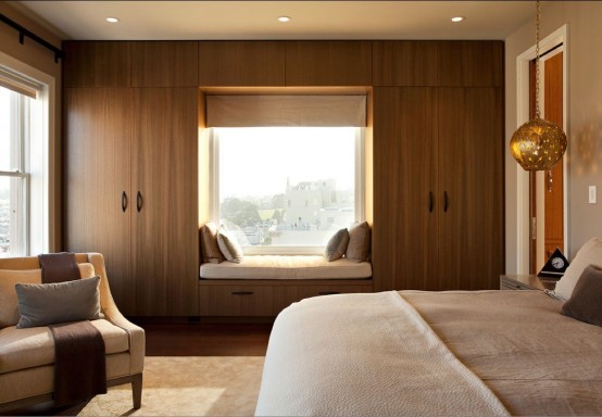 a sleek storage unit on both sides of the window, with a windowsill upholstered bench is a smart way to save some space