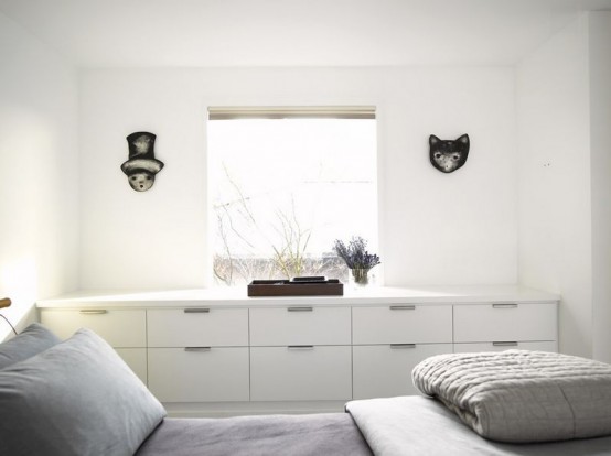 a large white dresser placed under the window for storage is a great idea if you don't need much storage space and want a decluttered and unobstructed look