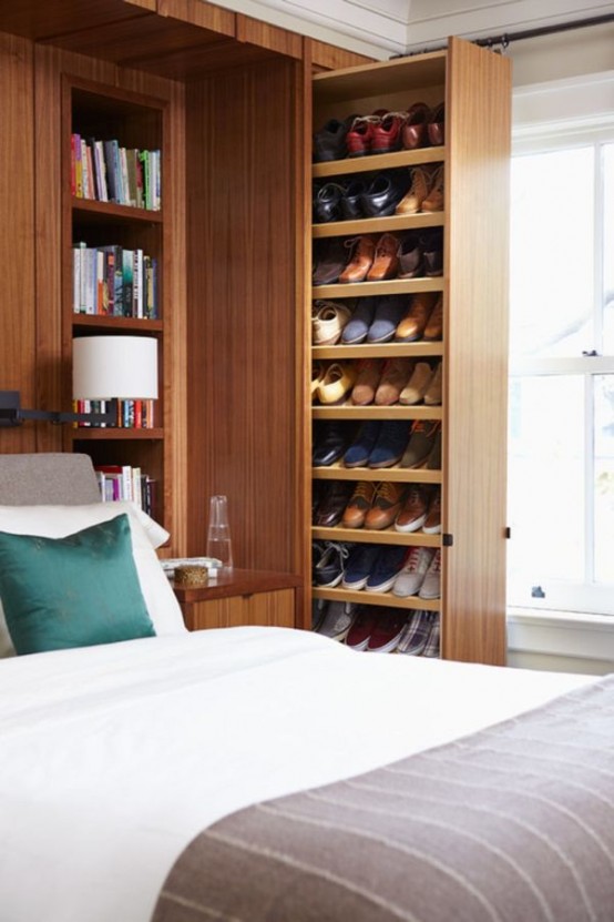 a large stained wood storage unit with shelves and drawers that can be retracted is a very cool and smart idea for a modern bedroom