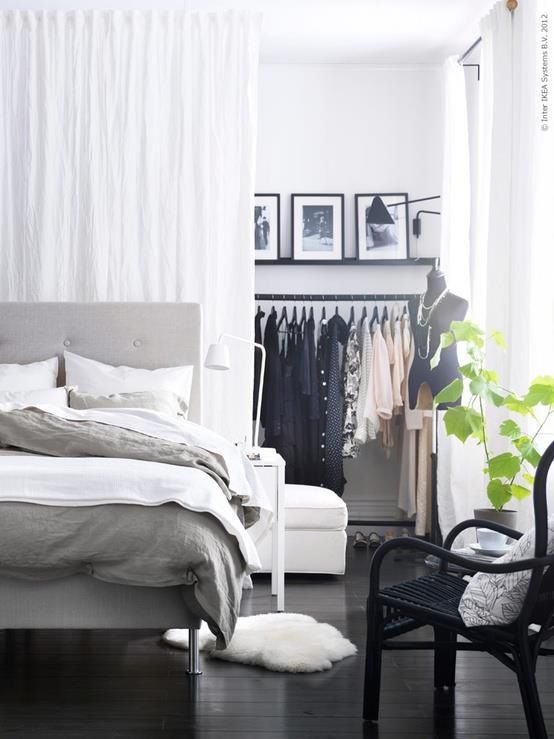 a makeshift closet hidden with a large white curtain    you get two airy spaces that can be separated with a curtain or merged anytime