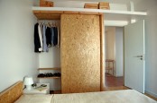 a small wardrobe with a sliding door and an additional open shelf over it is a cool idea for a modern and neutral bedroom, it doesn’t take much space