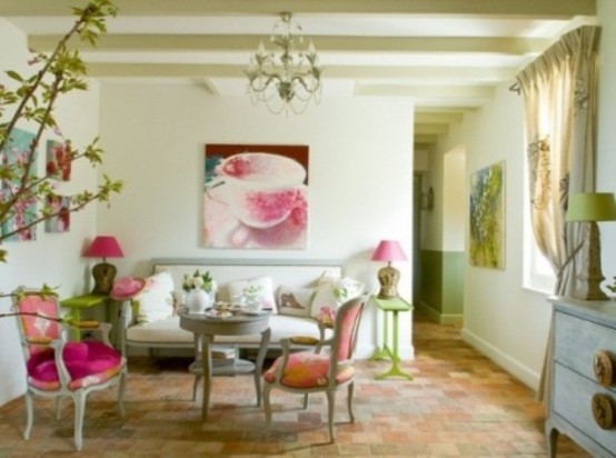 a vintage spring living room with green tables and lamps, pink lamps and chairs, bold artworks, greenery blooms