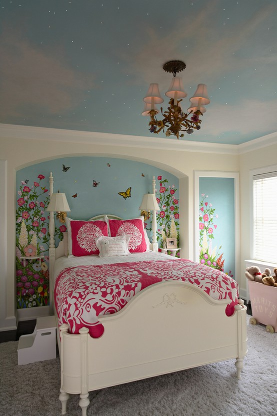 a pastel blue bedroom with a blue celestial ceiling, a blue accent wall with painted blooms, a white bed with pink printed bedding is a cool and bold space with plenty of color
