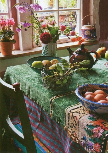 colorful layered textiles and potted blooms are amazing to create an ambience
