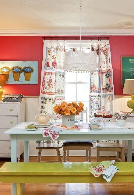 red walls, a mustard bench and colorful artworks and textiles for a bright boho kitchen