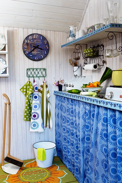 bright printed textiles and colorful countertops and shelves create a boho chic space