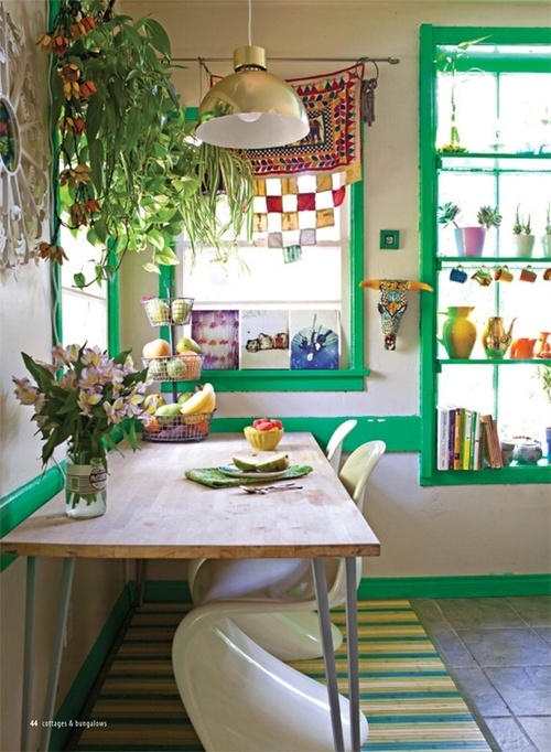 touches of bright green, colorful porcelain and lots of potted greenery and blooms
