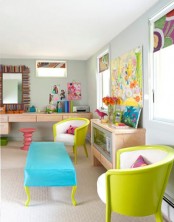 a bright home office dotted with colorful furniture – a turquoise ottoman, neon green chairs, colorful artwork and curtains is amazing