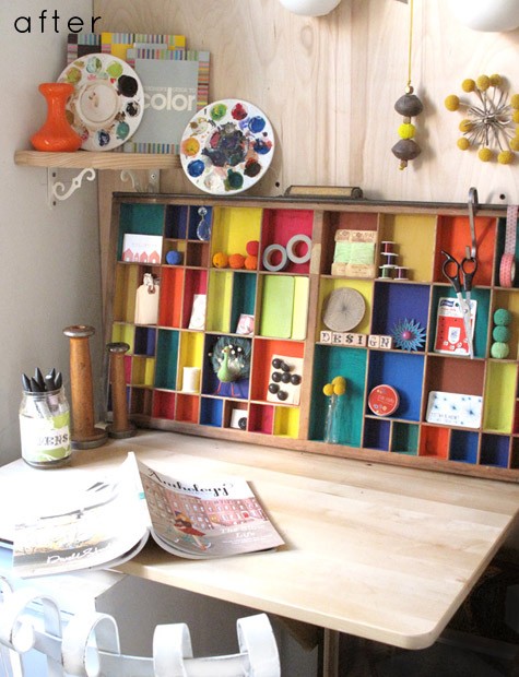 a home office nook done with a stained desk and a large colorful storage unit that doubles as decor, with some colorful accessories over it