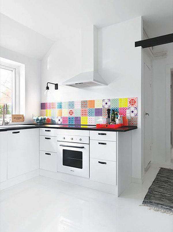 a colorful kitchen backsplash with super bright matching and mismatching tiles is a fun and cool idea