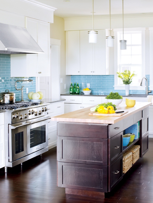 a neutral kitchen with a dark stained kitchen island, grey and neutral countertops, a blue mosaic tile backsplash and pendant lamps is a cool idea