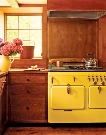 a vintage kitchen done in rich stain, with bold yellow touches is a lovely and chic space