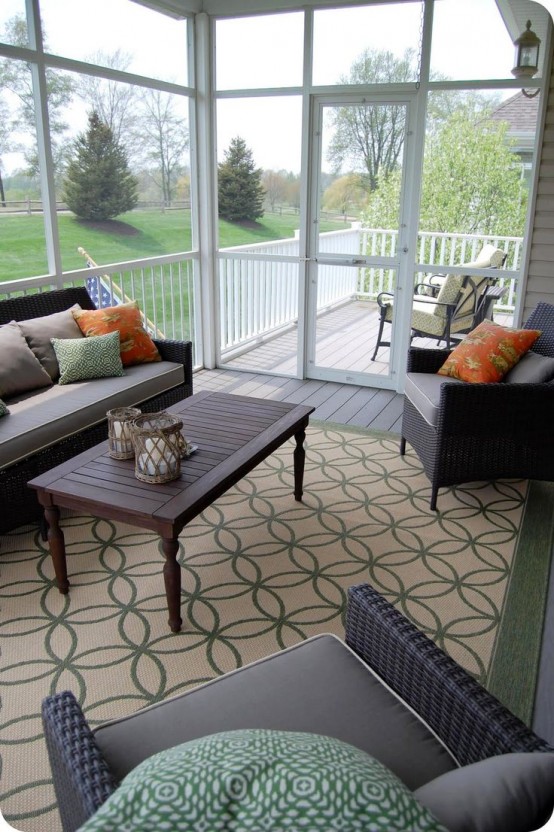 a rustic screened porch with dakr-stained wood and wicker furniture, colorful upholstery and pillows, colorful pillows and lanterns