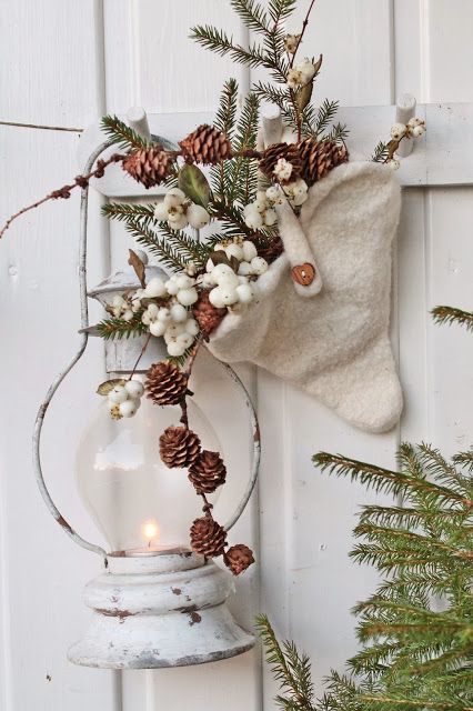 a lantern, a white cone with berries, fir branches with pinecones for delicate and chic vintage rustic decor