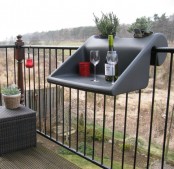 a grey railing holder can be used as a planter, planter holder and a small table for working or serving food and drinks