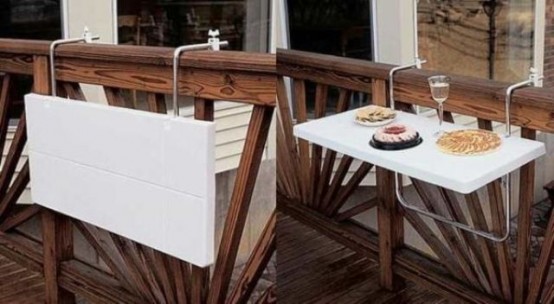 a white folding mini table that can be attached to the railing can be used for anything - from working to holding planters