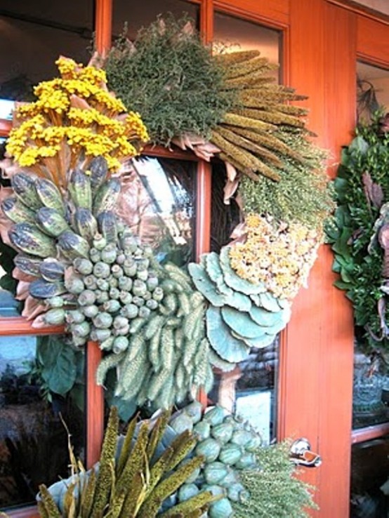 a super textural and catchy Thanksgiving wreath of various berries, veggies and blooms is a lovely idea with a strong rustic feel