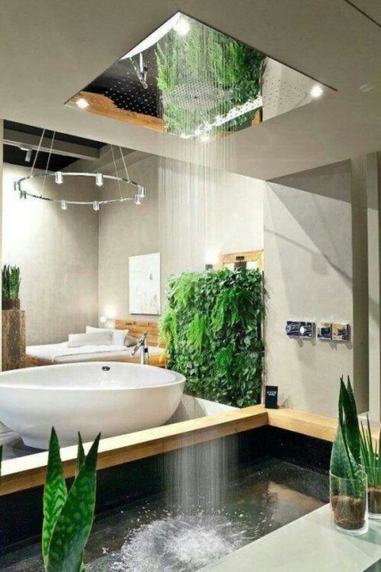 a contemporary neutral bathroom with an oval-shaped bathtub and greenery and a rain shower from above that feels like real rain