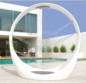 a unique and ultra-modenr outdoor round shower with shower heads built-in all around is a veyr fresh and bold idea