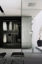 a minimalist black and white closet with a built-in shower space enclosed in glass and a rain shower is a gorgeous idea to rock