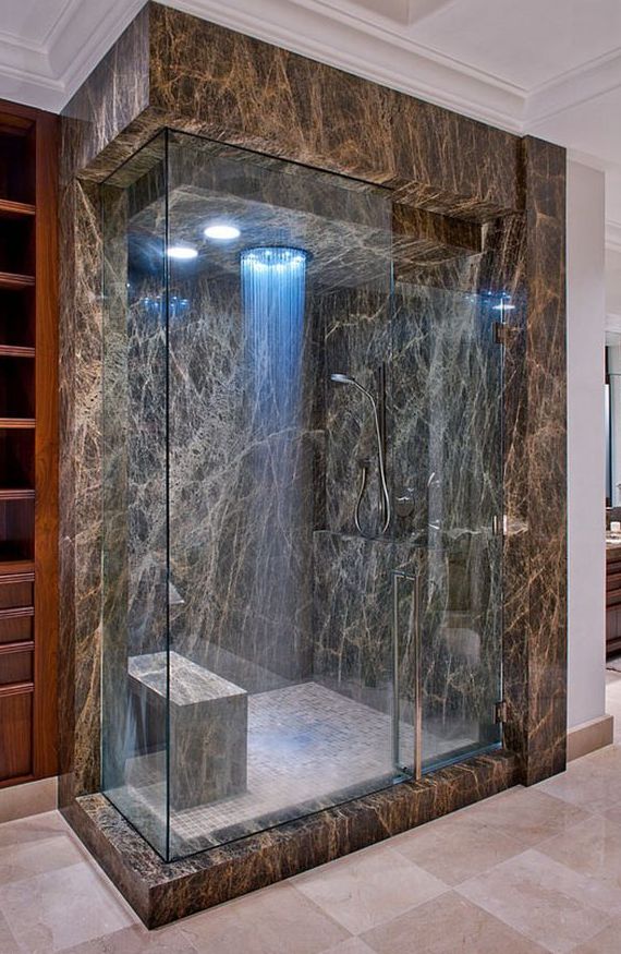 a sophisticated marble shower space with blue lights and a rain shower is a great idea for a chic and elegant bathroom