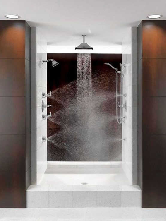 a bold and catchy shower space with a rain shower and shower heads integrated into the wall for massage