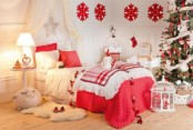 a bright and welcoming neutral and red Christmas kid’s room with red pillows, blankets, snowflakes and Christmas tree decor in red and white is very lovely