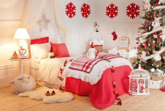 a bright and welcoming neutral and red Christmas kid's room with red pillows, blankets, snowflakes and Christmas tree decor in red and white is very lovely
