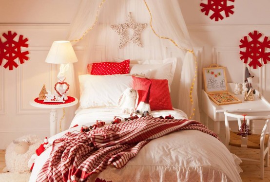 a beautiful neutral kid's room with chic red Christmas decor - red pillows, red snowflakes, blankets and mini nightstands plus a star on the bed is very cozy