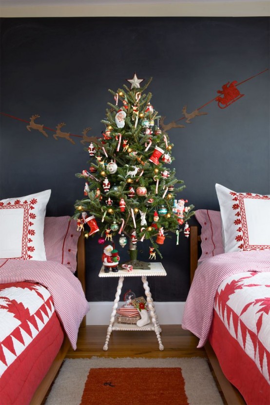 a Christmas tree decorated with bright ornaments and star banners and garlands is a lovely idea to rock in your kids' room, add holiday printed bedding
