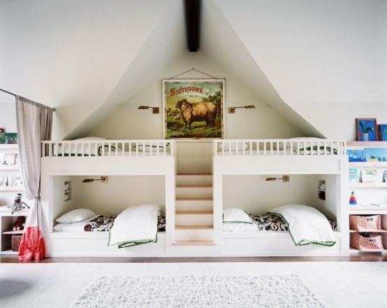 a small white kids' room with four built-in bunk beds, neutral and pastel bedding, built-in storage units and baskets is a cool space