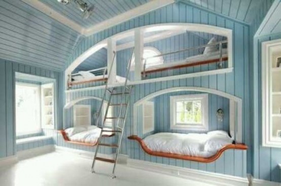 a coastal light blue kids' room with built-in bunk beds, a ladder and several windows to flood the space with light
