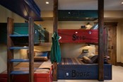 a rustic kids’ room with super bright kids’ bunk beds in navy and red, with a wooden ladder is a cool idea that saves space