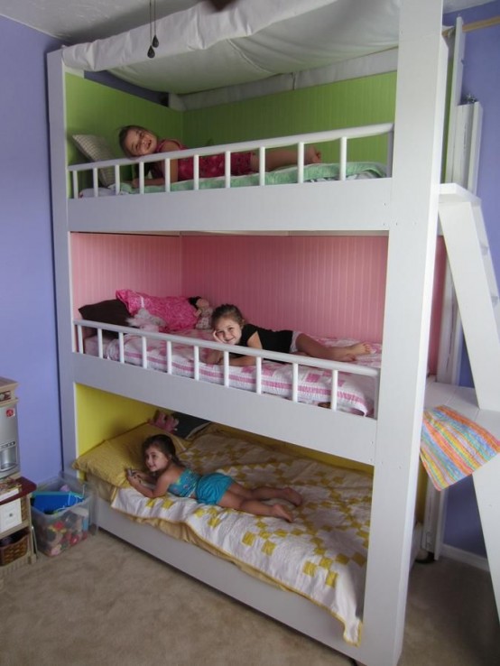 a colorful kids' room with a bunk bed and painted walls inside each space plus a ladder and colorful bedding