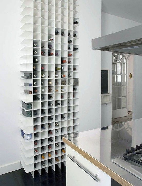 a minimalist wall-mounted storage unit for bottles is a stylish idea and a space-saving one