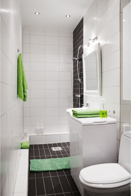 a laconic contemporary bathroom done with white and chocolate brown tiles and accented with bright green elements
