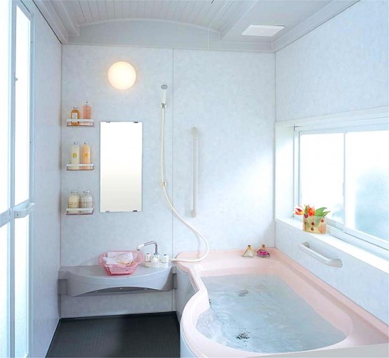 a small neutral bathroom with a pink bathtub, a sculptural vanity with a pink sink, shelves and a window for more light