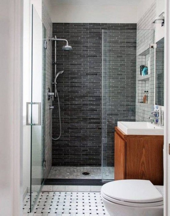 a small modern bathroom with a floating vanity, a shower space with a dark tile wall and a mosaic tile floor